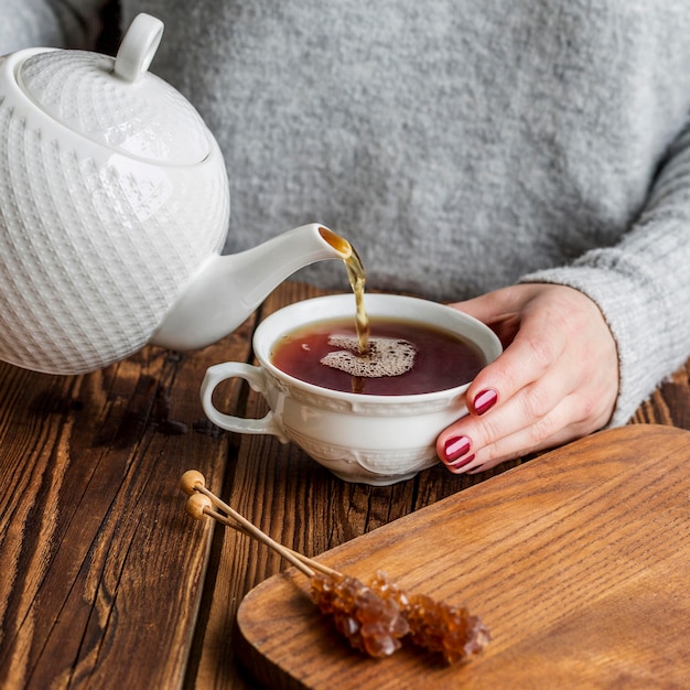 High angle of woman pouring tea concept