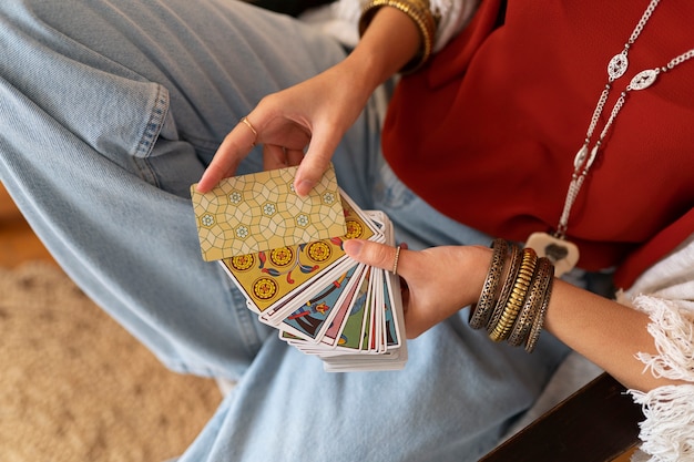 High angle woman reading tarot at home