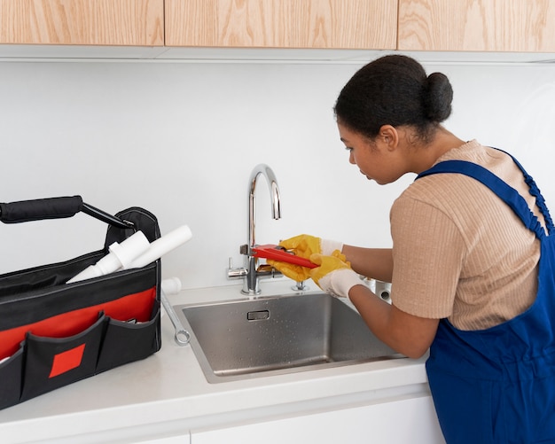 High angle woman working as plumber