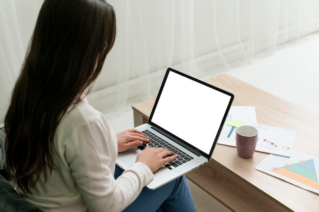 High angle woman working from home on a laptop