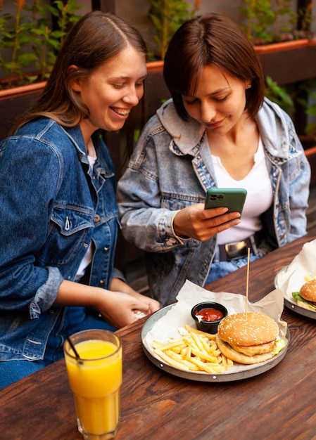 High angle of women taking picture of their food