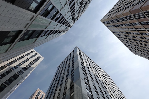 High bottom up perspective view of modern city skyscraper buildings with many windows in the urban cluster