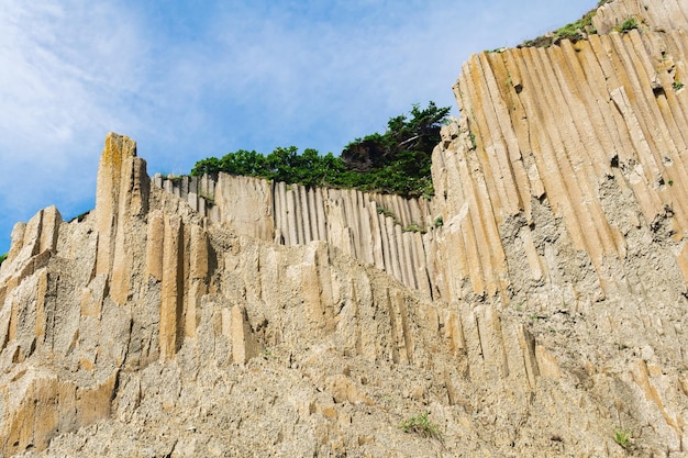 High coastal cliff made of columnar granite landscape on the island of Kunashir