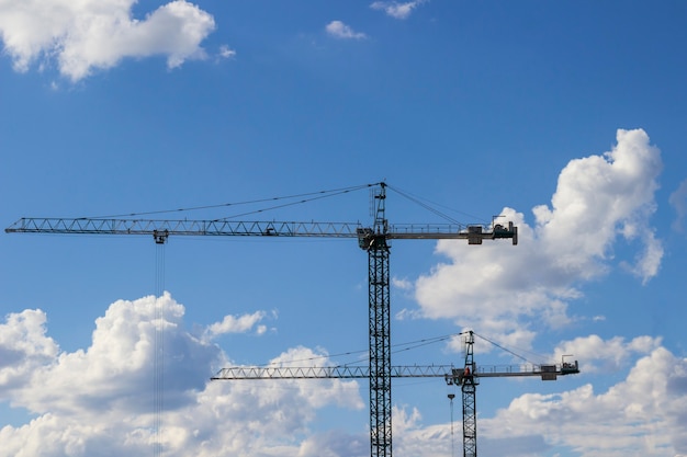 High construction cranes at a construction site
