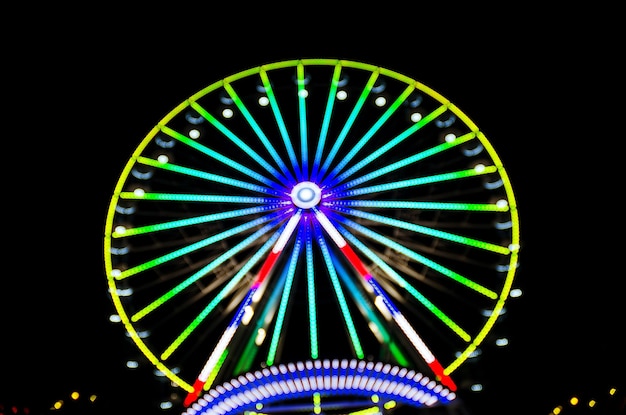 High Ferris Wheel on a sunset backdrop in our summer vacation. Amusement park ride