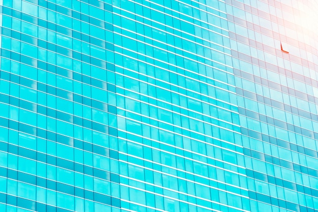 High glass modern building with blue sky and cloud at daylight for abstract background.