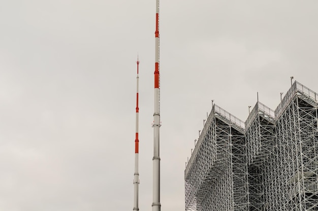 High lightning rods at the stadium near the stands.