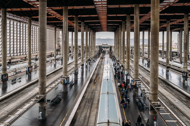 High perspective view of passengers and trains at Atocha the the main railway station in Madrid Spain