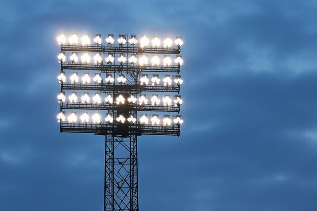 Photo high power floodlights illuminating a stadium under evening sky