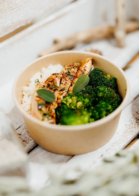 high protein food with broccholi chicken breast rice and aubergine in eco box delivered