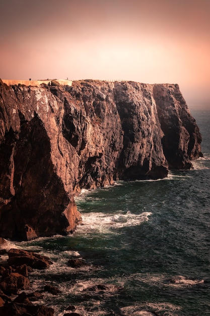 High red cliffs around Sao Vicente cape at south-west corner of Portugal, at the Algarve region