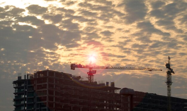 High rise building under construction with crane on top