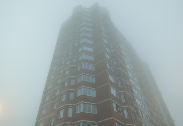 High-rise building in the fog. Russia early morning