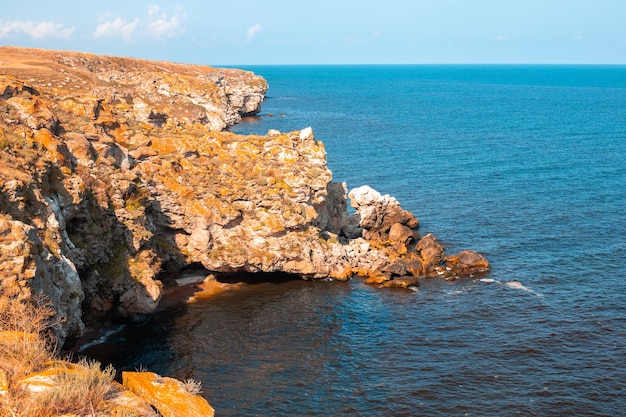 High rocky mountains and blue sea on a sunny day Seascape Travel and tourism