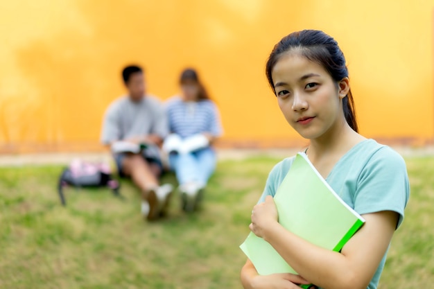 High school students; Group of happy teen Asian high school students outdoors.