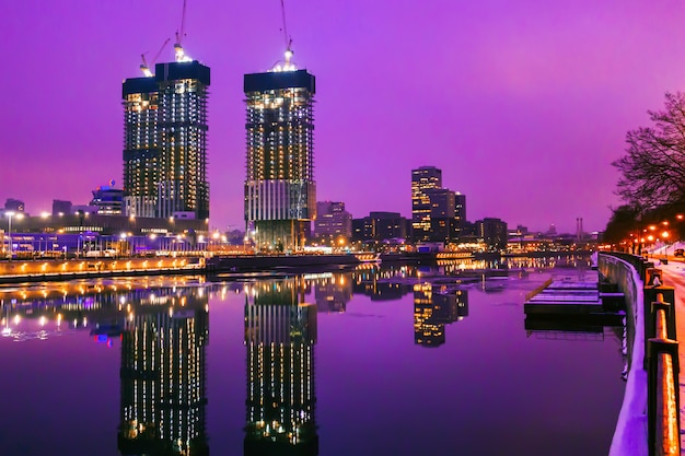 High skyscrapers in Moscow reflected in the water at night