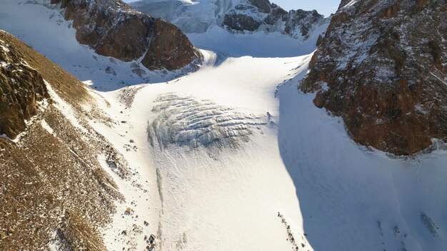 High snow capped mountains among large glaciers