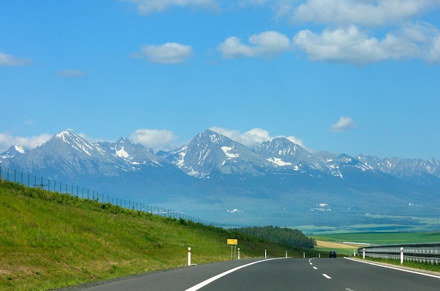 High Tatras spring view with snow on mountainside and highway (Slovakia)