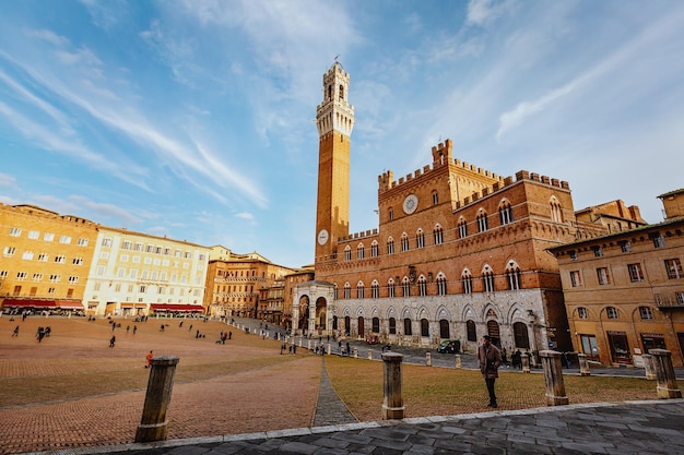 The high tower of Torre del Mangia in Piazza del Campo. Siena. Italy