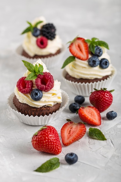 High view forest fruit and strawberries cupcakes