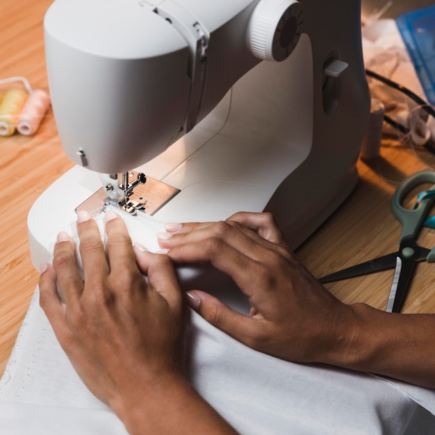 High view person sewing with a sewing machine