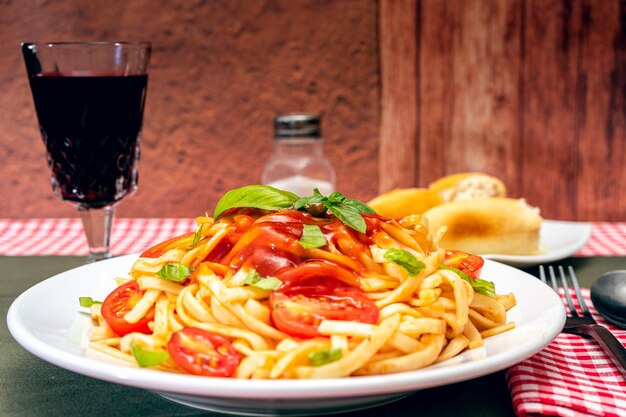 High view of a plate of spaghetti pasta with a delicious homemade tomato sauce with basil