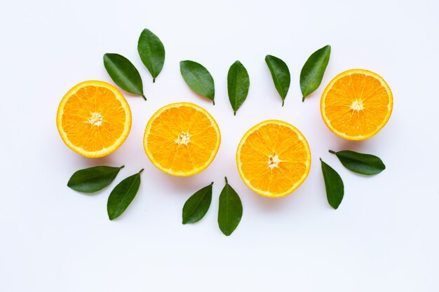 High vitamin C. Fresh orange citrus fruit with leaves isolated on white.