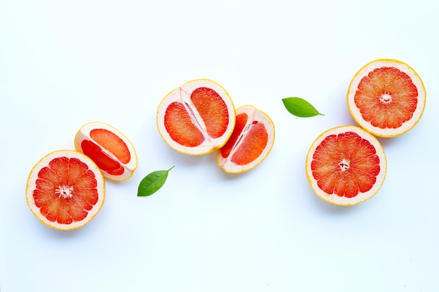 High vitamin C. Juicy grapefruit with leaves on white.