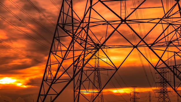 High voltage electric pole and transmission lines in the evening