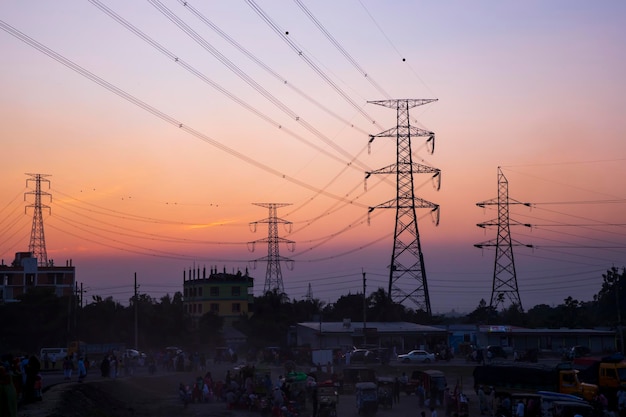 High Voltage electric pylons with colorful landscapes after sunset