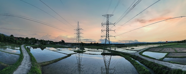 High voltage electric tower on sunset time and sky on sunset background. 