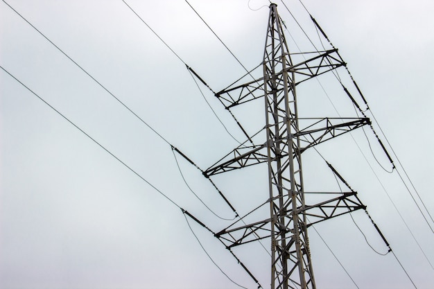 High voltage electrical towers in line. sky background