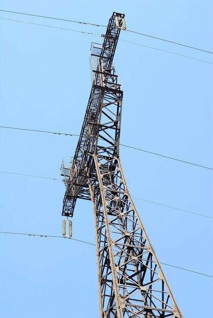 High voltage Electricity pylon against blue sky