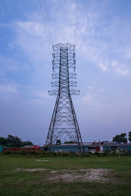 High voltage Electricity pylon under the cloudy blue sky