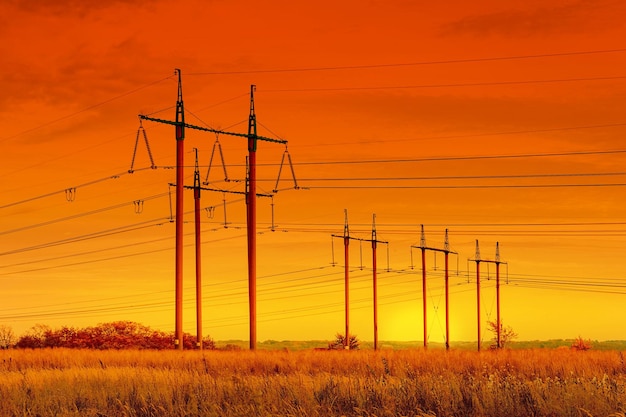 High voltage power line High voltage pylons in cloudy weather at sunset Energy and natural resources