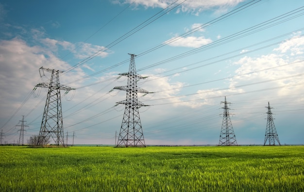 High voltage power lines against the blue sky