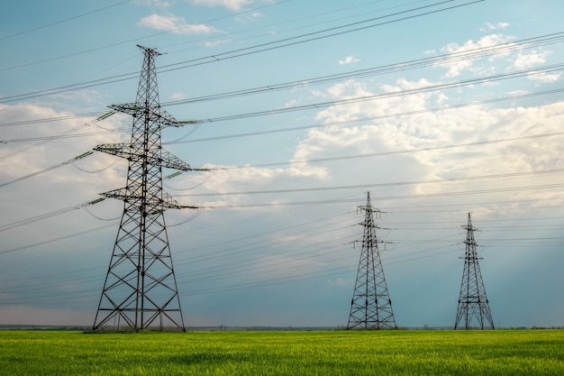 High voltage power lines against the blue sky