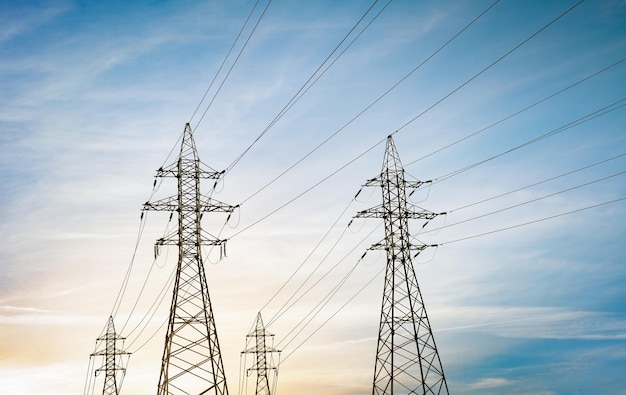 High voltage power lines against a blue sunset sky highvoltage transmission tower