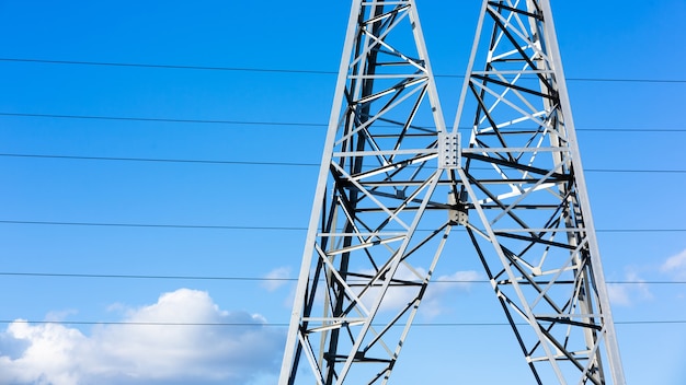 High voltage power lines at sunset, high voltage electric transmission tower.