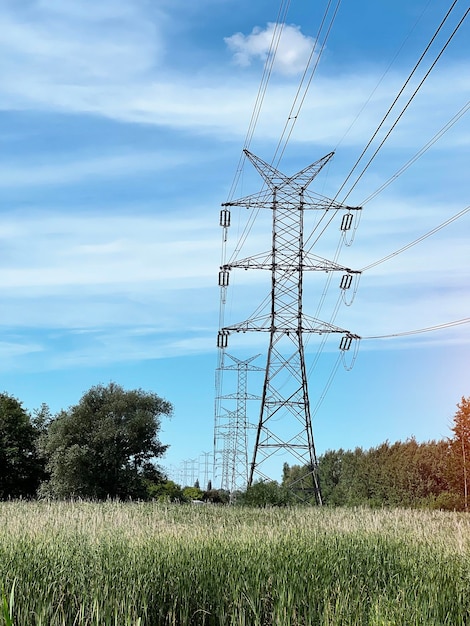 High voltage pylon in the field Energy distribution and supply between cities in rural areas concept