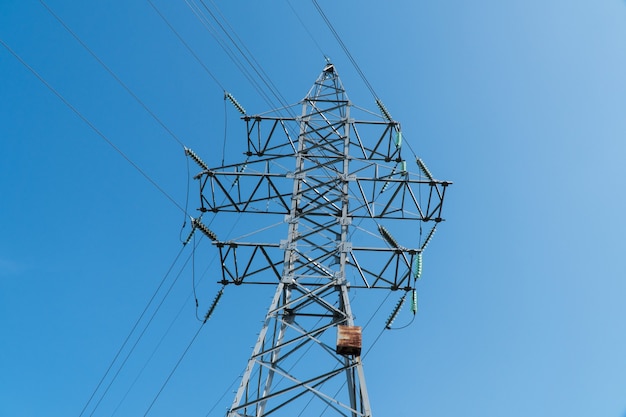 High voltage tower against the blue sky