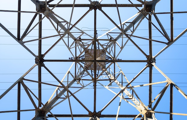 High voltage tower poles bottom view Background of triangles and rectangles on background of the sky