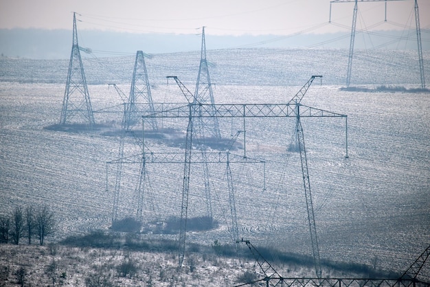 High voltage tower with electric power lines transfening electrical energy through cable wires