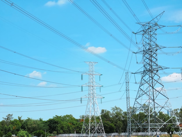 High Voltage Towers and Power Lines Against Vibrant Blue Cloudy Sky