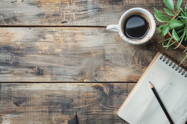 Highangle view table with pencils notebook coffee cup free space on the wooden work desk