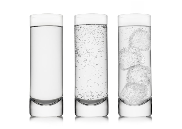 Highball glasses with sparkling and still mineral water with ice cubes on white