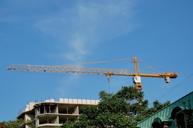 Highrise construction crane against the blue sky