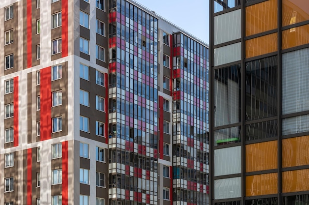 Highrise residential apartment buildings of dense development with a large number of windows and ba