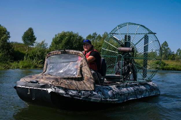 Highspeed riding in an airboat on the river on a summer day with splashes and waves