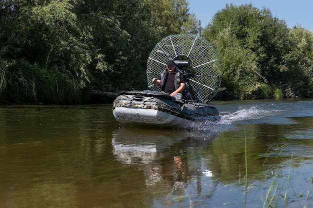 Highspeed riding in an airboat on the river on a summer day with splashes and waves